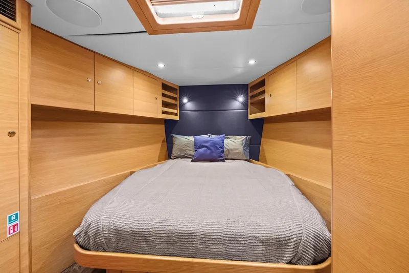 Slide: The Image of Luxurious cabin interior of a 2013 Hylas 63 yacht with cozy bedding and wooden cabinetry. - 61