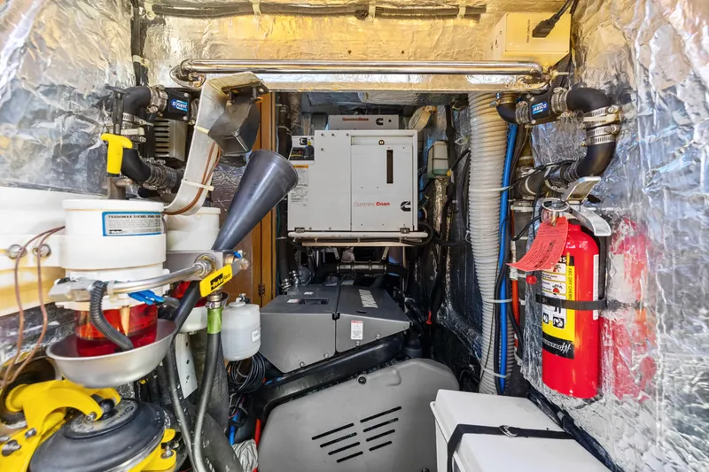 Slide: The Image of Engine room of a 2013 Hylas 63 yacht with Cummins Onan generator and safety equipment. - 66