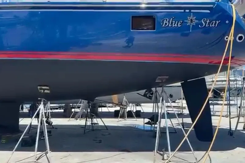 Slide: The Image of 2013 Hylas 63 yacht "Blue Star" on stands, blue hull with red stripe. - 79