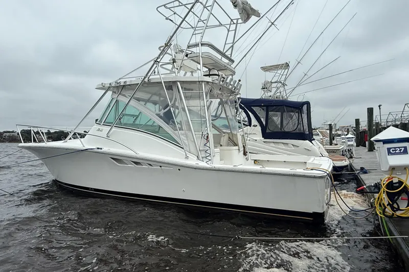 Slide: The Image of 2003 Luhrs 32 Open boat docked on a cloudy day. - 1