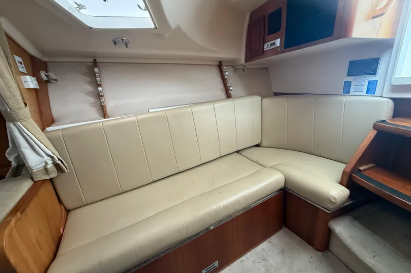 Slide: The Image of 2003 Luhrs 32 Open interior with beige leather seating and wooden accents. - 10