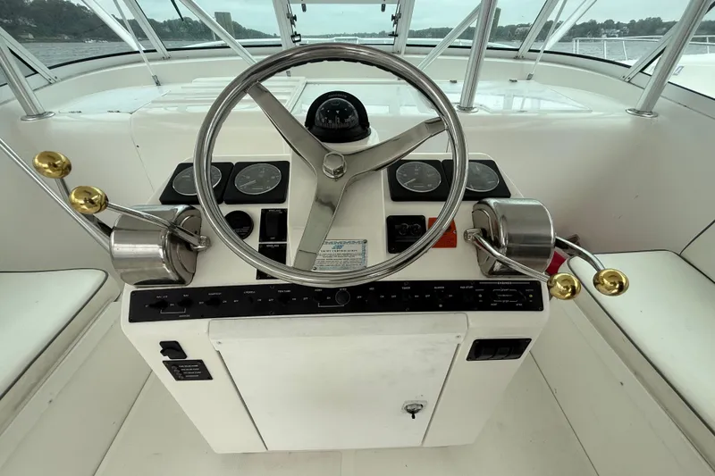 Slide: The Image of Helm of 2003 Luhrs 32 Open boat with steering wheel and controls. - 2