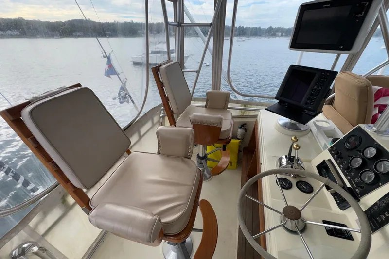 Slide: The Image of Interior of 1986 Viking 35 Convertible boat with helm, steering wheel, and navigation equipment. - 10