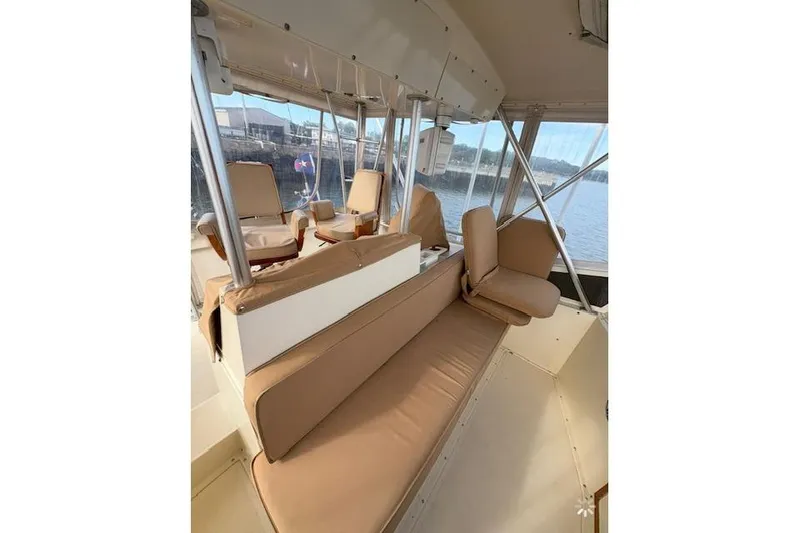 Slide: The Image of 1986 Viking 35 Convertible boat on calm water under a cloudy sky. - 2