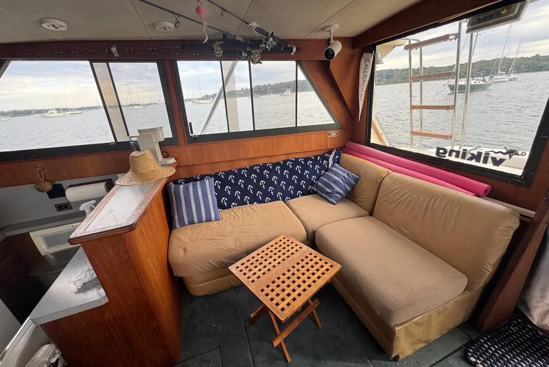 Slide: The Image of Cozy interior of 1986 Viking 35 Convertible yacht with comfortable seating and scenic water view. - 20