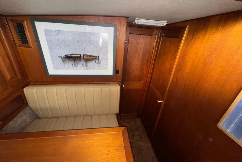 Slide: The Image of 1986 Viking 35 Convertible interior with wood paneling and framed nautical artwork. - 21