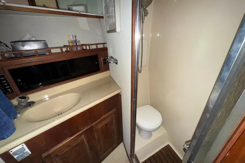 Slide: The Image of 1986 Viking 35 Convertible yacht bathroom with sink, toilet, and shower. - 27