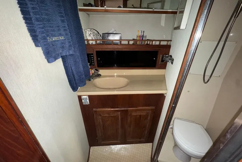 Slide: The Image of 1986 Viking 35 Convertible yacht bathroom with sink, mirror, and toilet. - 28