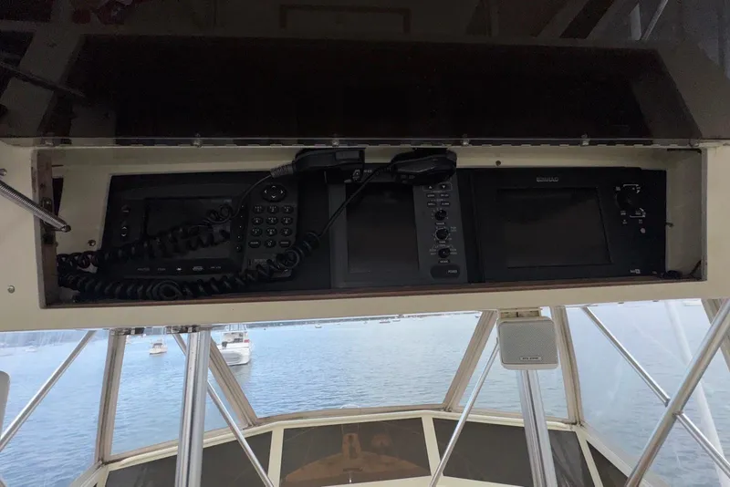 Slide: The Image of 1986 Viking 35 Convertible boat dashboard with navigation equipment and radio. - 30