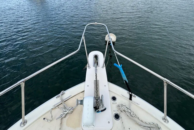 Slide: The Image of Bow of 1986 Viking 35 Convertible boat with anchor chain over water. - 31