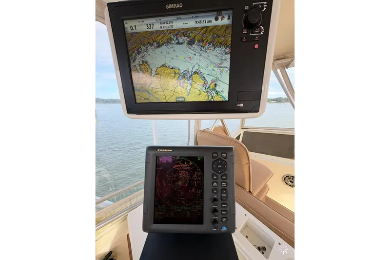 Slide: The Image of Navigation equipment on a 1986 Viking 35 Convertible boat, featuring Simrad and Furuno displays. - 36