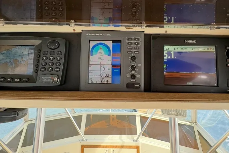 Slide: The Image of Control panel of a 1986 Viking 35 Convertible boat with navigation displays. - 37