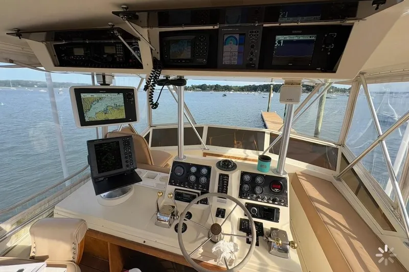 Slide: The Image of 1986 Viking 35 Convertible helm with navigation equipment and scenic water view. - 39