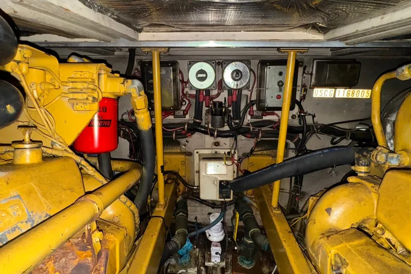 Slide: The Image of Engine room of a 1986 Viking 35 Convertible boat, showcasing mechanical components and wiring. - 41