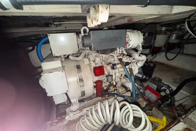 Slide: The Image of Engine room of a 1986 Viking 35 Convertible boat, featuring mechanical components. - 44