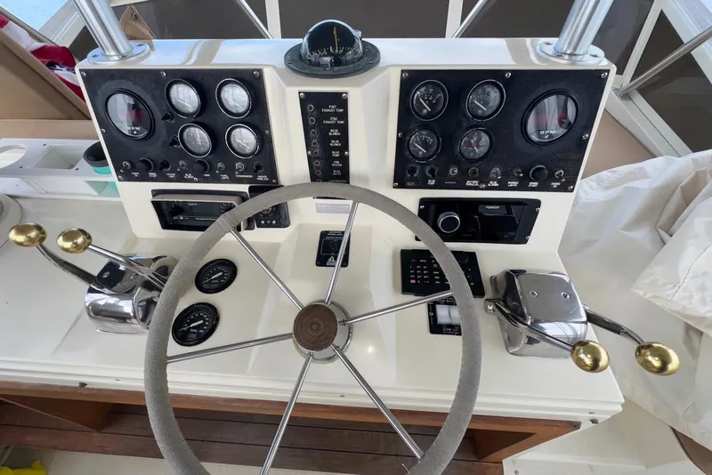 Slide: The Image of Control panel of a 1986 Viking 35 Convertible boat with steering wheel and gauges. - 8