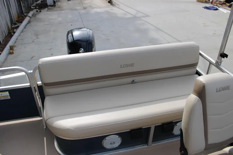 Slide: The Image of 2016 Lowe Ultra 182 Fish & Cruise boat interior with beige seating and motor. - 16