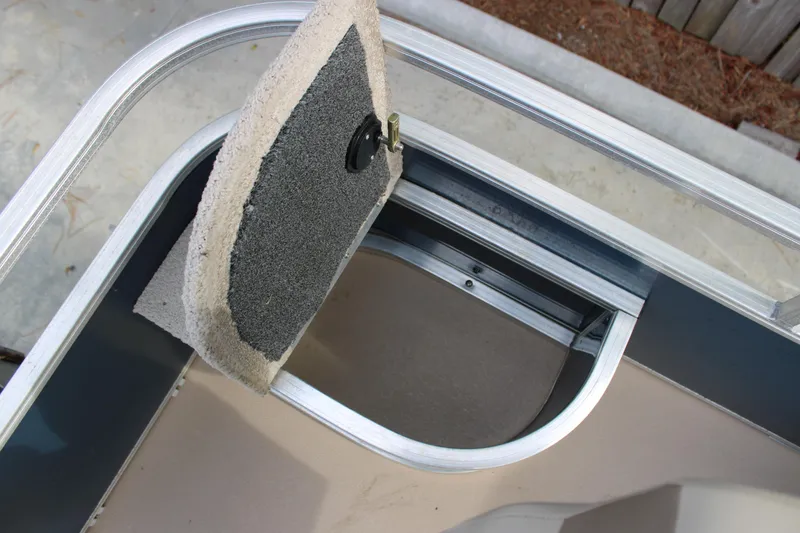 Slide: The Image of 2016 Lowe Ultra 182 Fish & Cruise boat storage compartment with carpeted lid. - 8