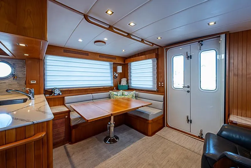 Slide: The Image of Luxurious 2019 Kadey-Krogen 44 AE yacht interior with elegant wood finishes and cozy seating area. - 13