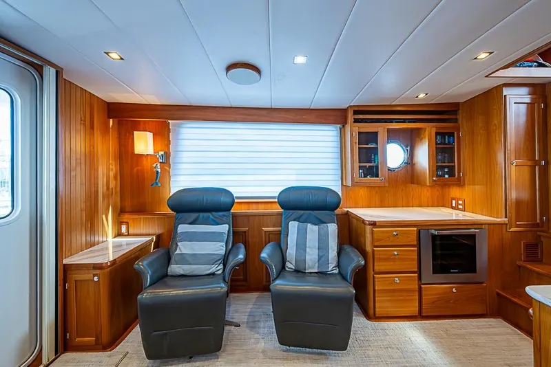 Slide: The Image of Luxurious interior of 2019 Kadey-Krogen 44 AE yacht with leather chairs and wooden cabinetry. - 14