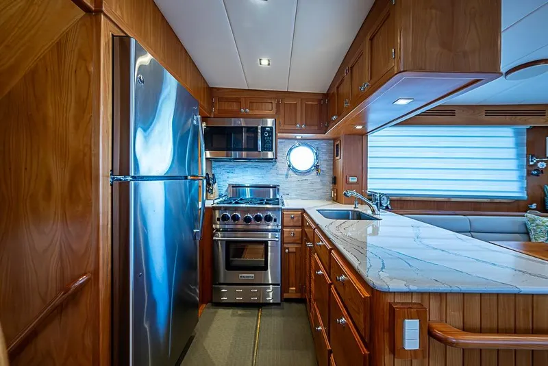 Slide: The Image of Luxurious 2019 Kadey-Krogen 44 AE yacht kitchen with modern appliances and elegant wood cabinetry. - 18