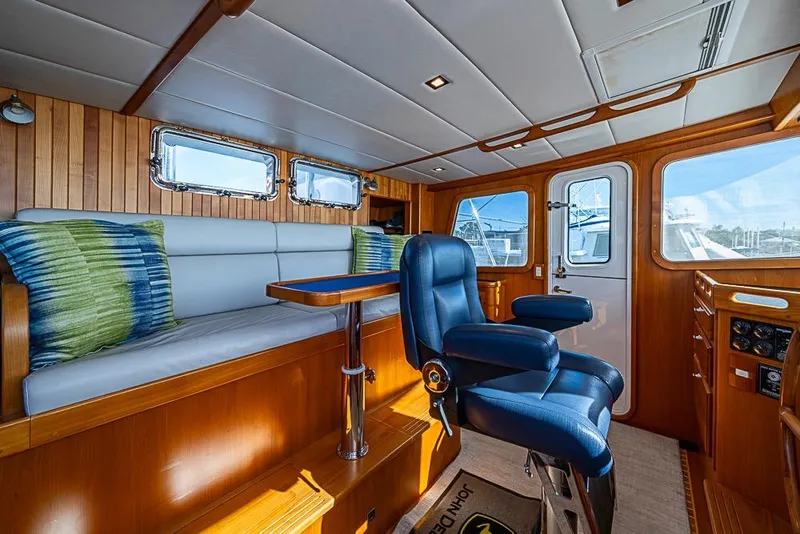 Slide: The Image of 2019 Kadey-Krogen 44 AE yacht interior with plush seating and wooden accents. - 21