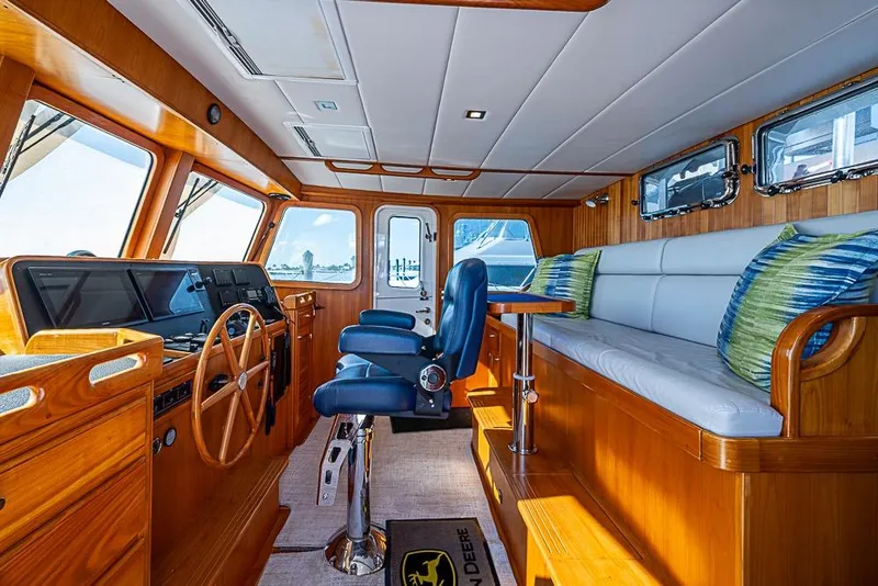 Slide: The Image of Luxurious interior of 2019 Kadey-Krogen 44 AE yacht with wooden finishes and plush seating. - 24