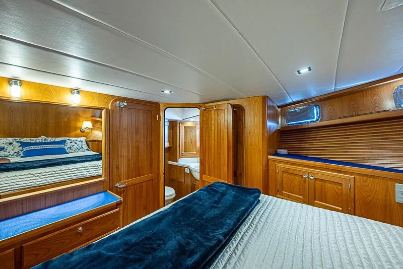 Slide: The Image of Luxurious 2019 Kadey-Krogen 44 AE yacht cabin with elegant wood finish and cozy bedding. - 31