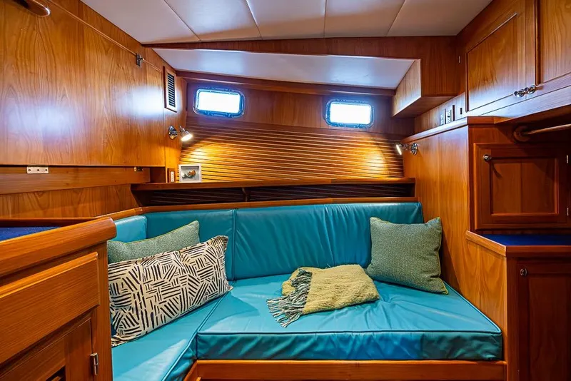Slide: The Image of Cozy interior of 2019 Kadey-Krogen 44 AE yacht with teal seating and wooden finish. - 32