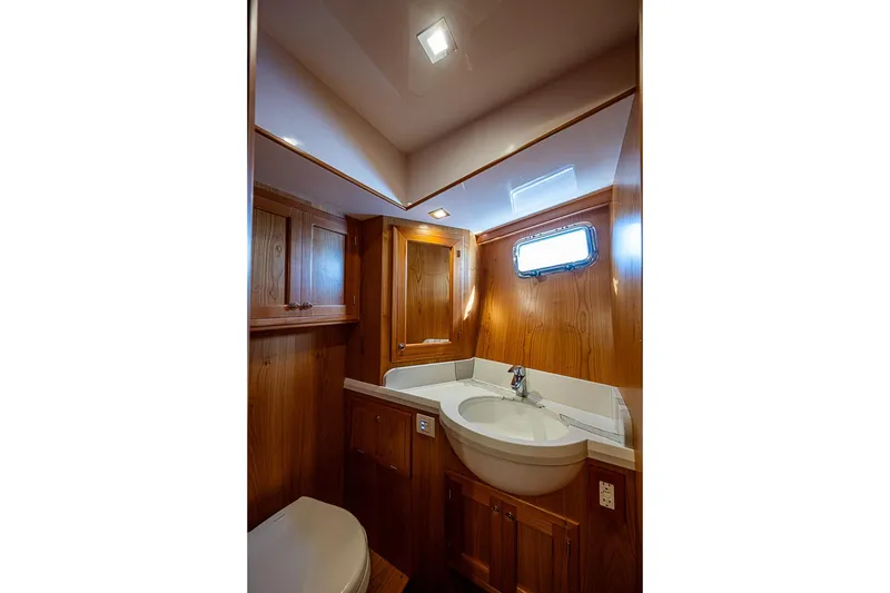 Slide: The Image of 2019 Kadey-Krogen 44 AE yacht bathroom with wooden cabinetry and modern fixtures. - 35