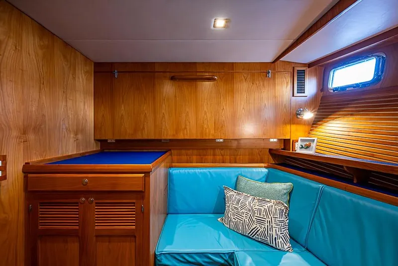 Slide: The Image of Luxurious 2019 Kadey-Krogen 44 AE yacht interior with wood paneling and blue seating. - 36