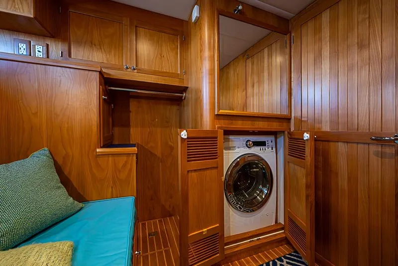 Slide: The Image of Laundry area in 2019 Kadey-Krogen 44 AE yacht with wood cabinetry and seating. - 40