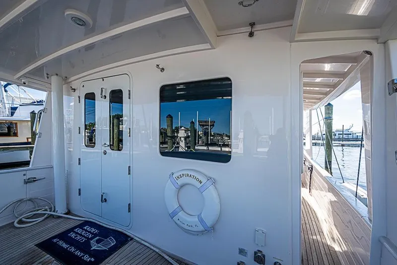 Slide: The Image of 2019 Kadey-Krogen 44 AE yacht deck with reflection and life preserver. - 44
