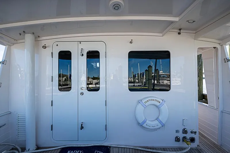 Slide: The Image of 2019 Kadey-Krogen 44 AE yacht deck with double doors and life preserver. - 45