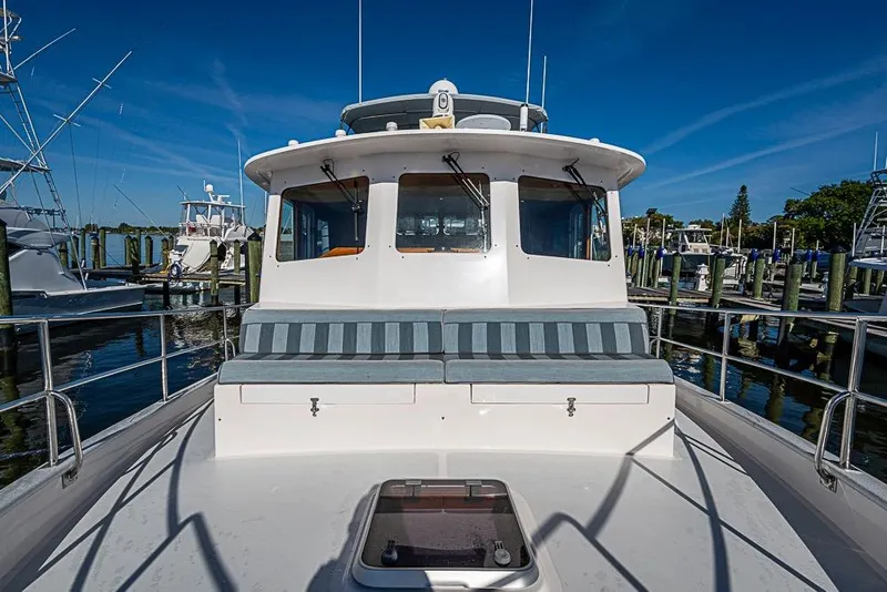 Slide: The Image of 2019 Kadey-Krogen 44 AE yacht docked at marina under clear blue sky. - 48