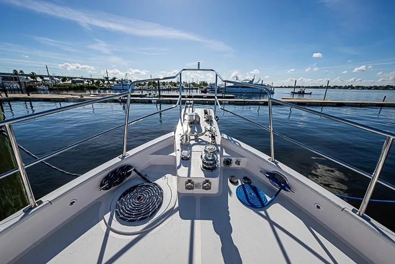 Slide: The Image of Bow view of 2019 Kadey-Krogen 44 AE yacht docked in a sunny marina. - 50