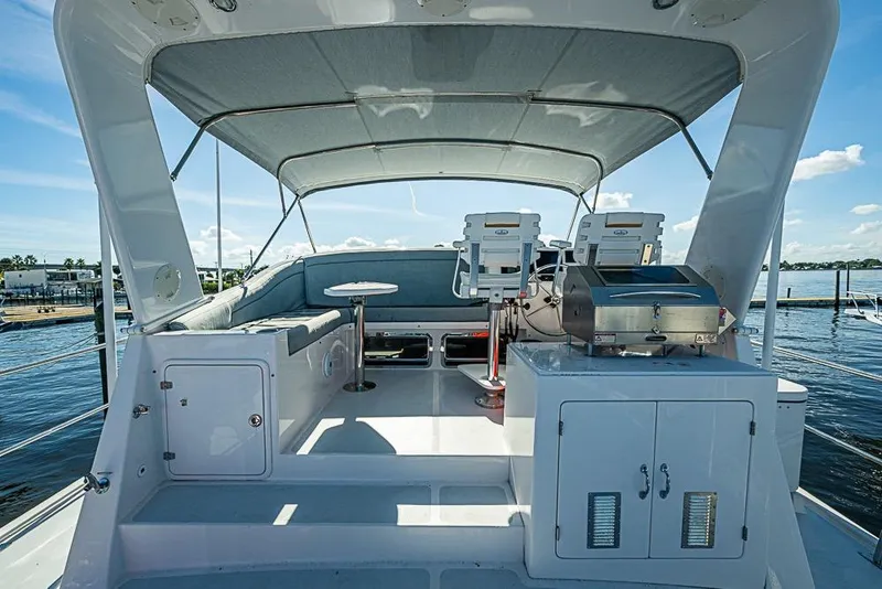 Slide: The Image of Flybridge of 2019 Kadey-Krogen 44 AE yacht with seating and grill, under canopy. - 53