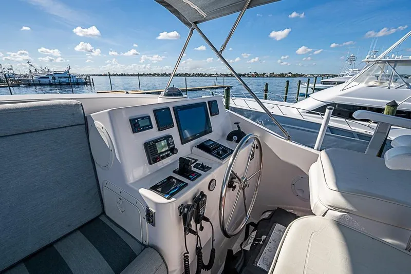 Slide: The Image of 2019 Kadey-Krogen 44 AE yacht helm with navigation equipment, docked by the water. - 54