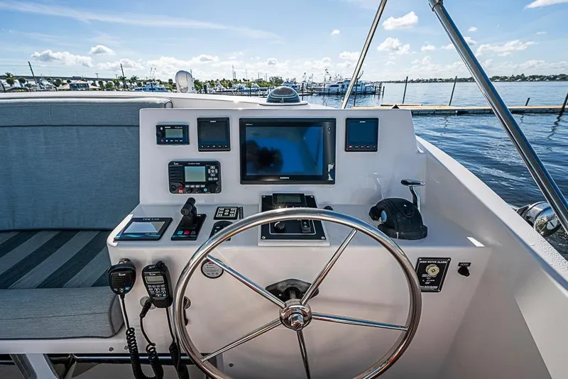 Slide: The Image of 2019 Kadey-Krogen 44 AE yacht helm with navigation instruments and steering wheel. - 55