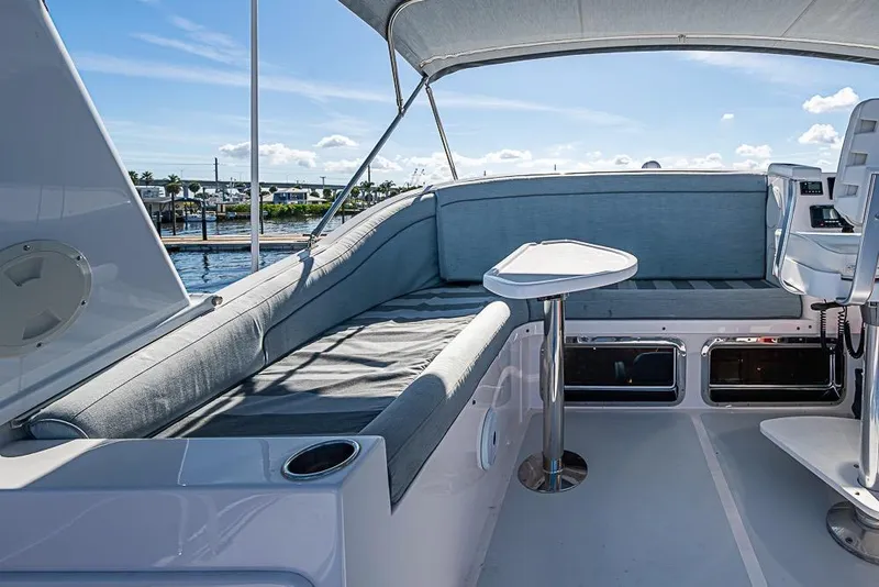 Slide: The Image of Luxurious 2019 Kadey-Krogen 44 AE yacht deck with seating and table, overlooking marina. - 57