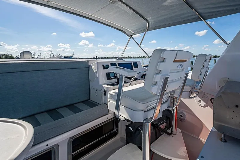Slide: The Image of 2019 Kadey-Krogen 44 AE yacht helm with seating, overlooking serene waters. - 60