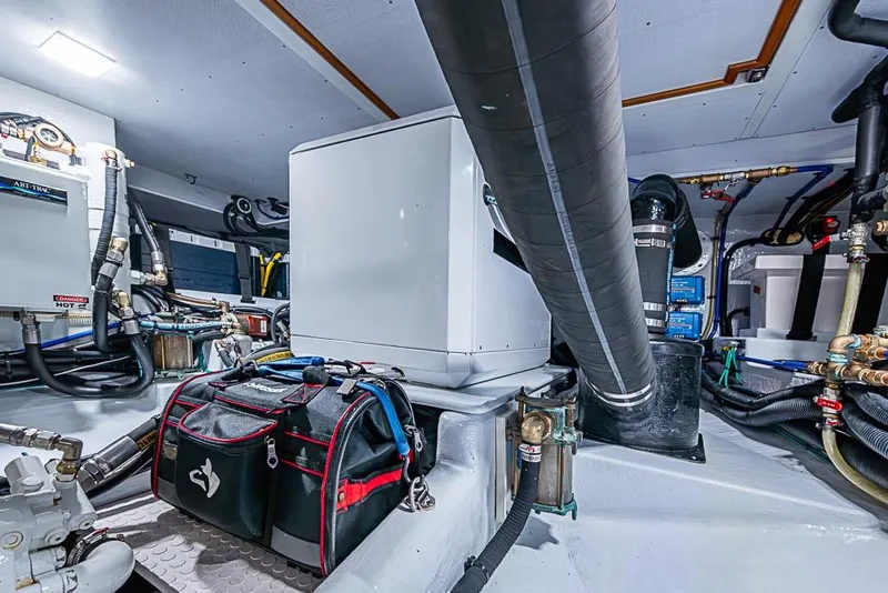 Slide: The Image of Engine room of 2019 Kadey-Krogen 44 AE yacht, featuring equipment and tool bag. - 67