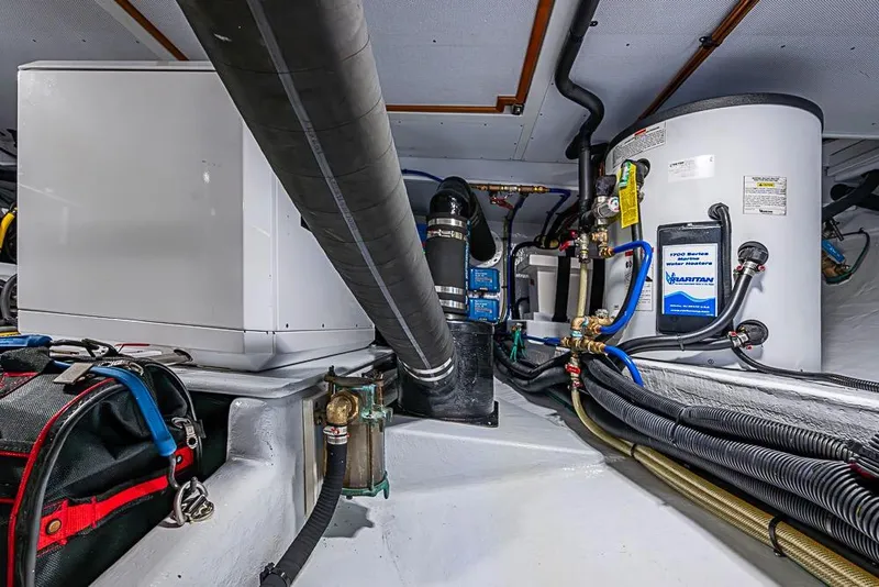 Slide: The Image of Engine room of 2019 Kadey-Krogen 44 AE yacht, showcasing equipment and piping. - 69