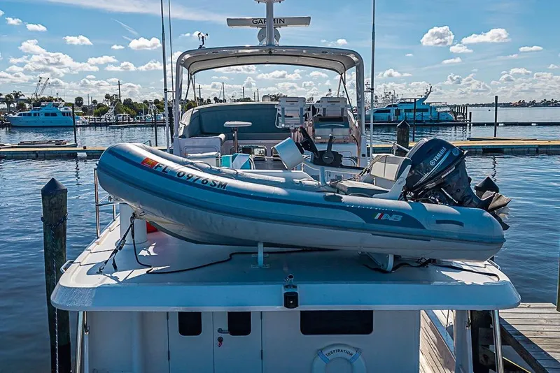 Slide: The Image of 2019 Kadey-Krogen 44 AE yacht with dinghy at marina dock. - 7