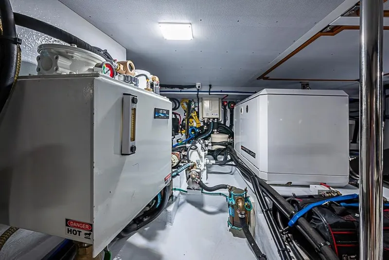 Slide: The Image of Engine room of 2019 Kadey-Krogen 44 AE yacht, featuring modern equipment and wiring. - 71