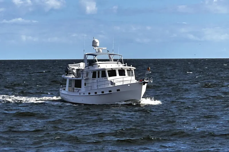 Slide: The Image of 2019 Kadey-Krogen 44 AE yacht cruising on open sea under clear skies. - 9
