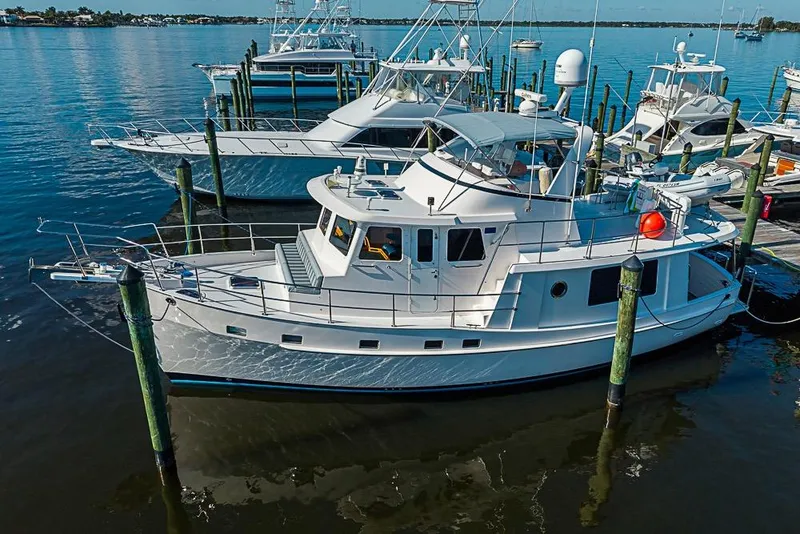 Slide: The Image of 2019 Kadey-Krogen 44 AE yacht docked at marina, surrounded by water. - 0