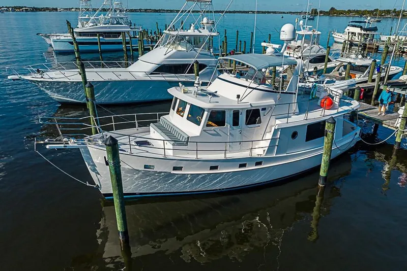 Slide: The Image of 2019 Kadey-Krogen 44 AE yacht docked at marina, surrounded by other boats. - 1
