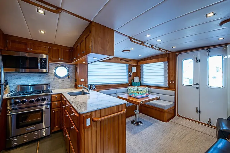 Slide: The Image of Luxurious 2019 Kadey-Krogen 44 AE yacht interior with modern kitchen and cozy dining area. - 17