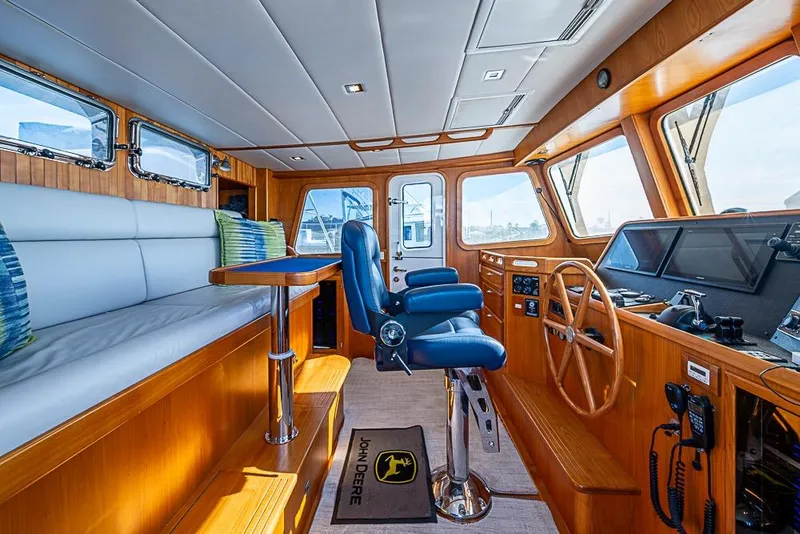 Slide: The Image of 2019 Kadey-Krogen 44 AE yacht interior with helm, seating, and navigation equipment. - 23
